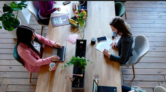 two persons are working in an office