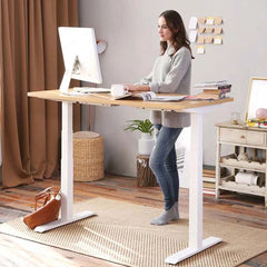 A woman using the desk in a standing position